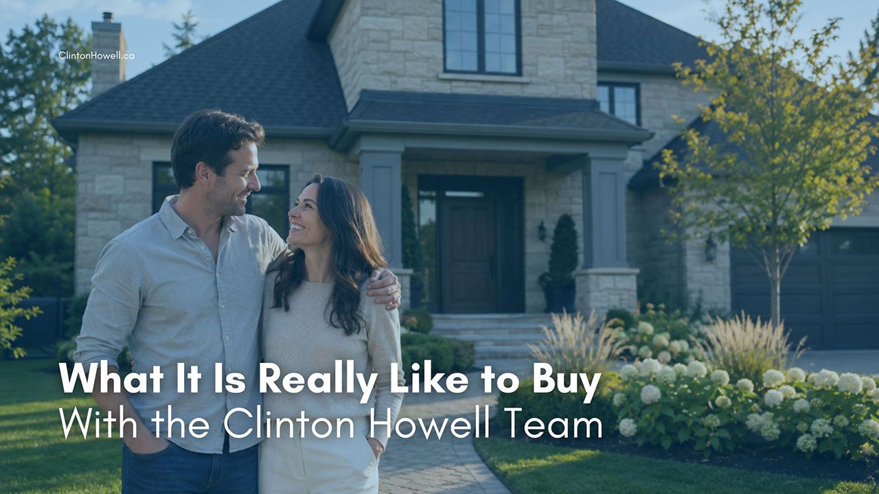 Smiling couple outside a stone home in Burlington, with the title What It Is Really Like to Buy With the Clinton Howell Team